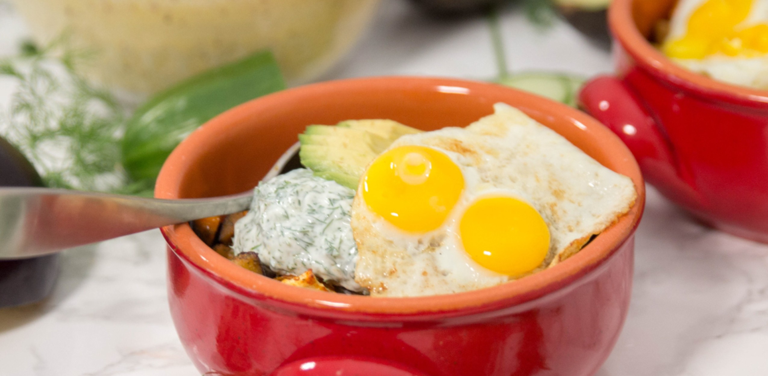 Fried quail eggs in bowl on avocado and rice